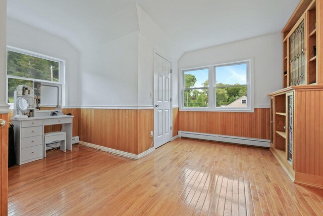 571 Farm To Market Rd, Brewster, NY 10509 - unfurnished office with a baseboard radiator, wood-type flooring, wainscoting, plenty of natural light, and lofted ceiling