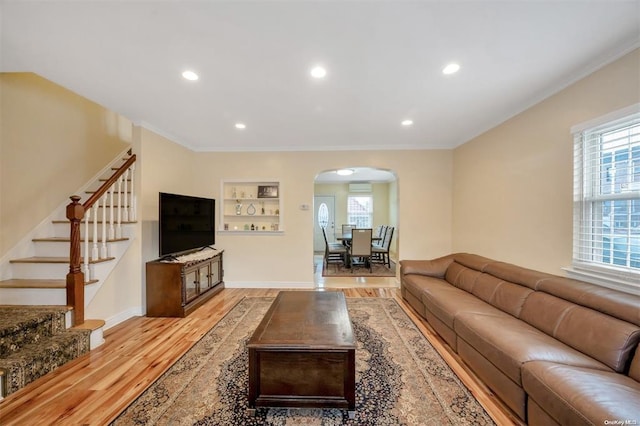21-89 47th St, Long Island City, NY 11105 - living area featuring arched walkways, light wood finished floors, healthy amount of natural light, stairway, and recessed lighting