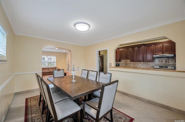 21-89 47th St, Long Island City, NY 11105 - dining room featuring arched walkways, ornamental molding, and light tile patterned flooring