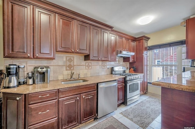 21-89 47th St, Long Island City, NY 11105 - kitchen featuring stainless steel appliances, a sink, under cabinet range hood, and tasteful backsplash