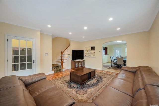 21-89 47th St, Long Island City, NY 11105 - living area featuring arched walkways, ornamental molding, recessed lighting, stairs, and light wood-style floors