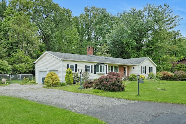 19 Leicester Rd, Briarcliff Manor, NY 10510 - ranch-style home with a chimney, an attached garage, and driveway