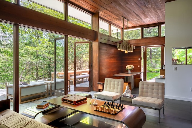 100 Old Pascack Rd, Pearl River, NY 10965 - living room featuring wooden ceiling, a chandelier, baseboards, and wooden walls