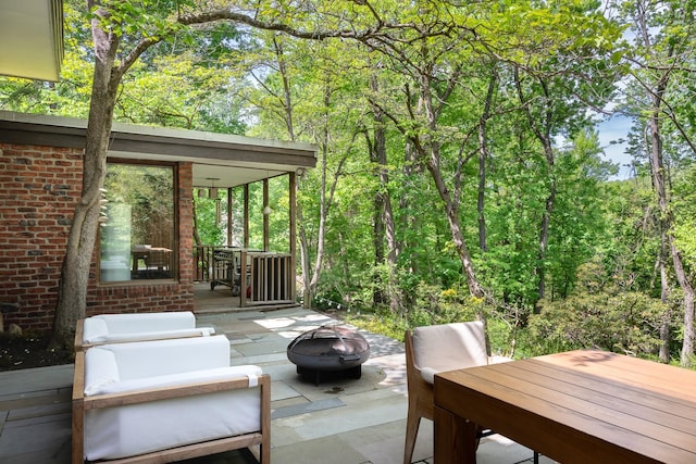 100 Old Pascack Rd, Pearl River, NY 10965 - view of patio featuring an outdoor fire pit and a view of trees