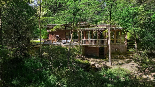 100 Old Pascack Rd, Pearl River, NY 10965 - rear view of property with a view of trees, a patio, and a wooden deck
