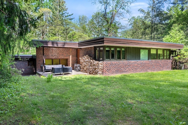 100 Old Pascack Rd, Pearl River, NY 10965 - back of house featuring an outdoor hangout area, a yard, brick siding, and a patio