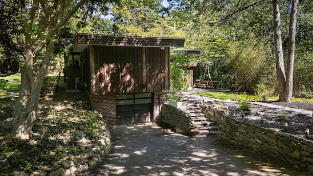 100 Old Pascack Rd, Pearl River, NY 10965 - view of outdoor structure featuring driveway, a garage, and cooling unit