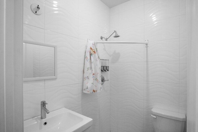 87 Horton Dr, Monsey, NY 10952 - bathroom with tile walls, a sink, toilet, and a tile shower