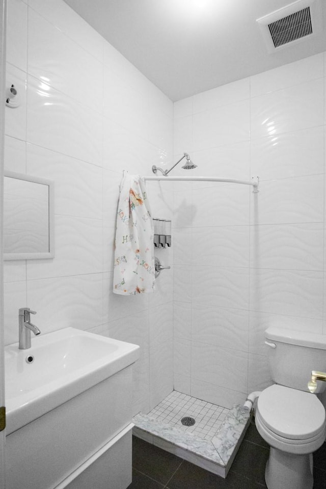87 Horton Dr, Monsey, NY 10952 - full bath featuring tile walls, a stall shower, vanity, tile patterned flooring, and toilet