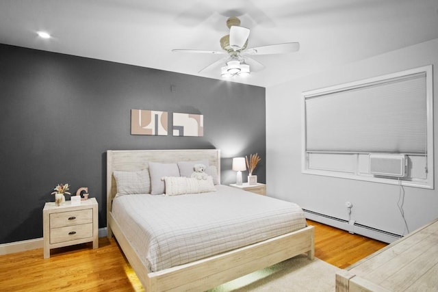 87 Horton Dr, Monsey, NY 10952 - bedroom featuring a baseboard heating unit, wood finished floors, and a ceiling fan