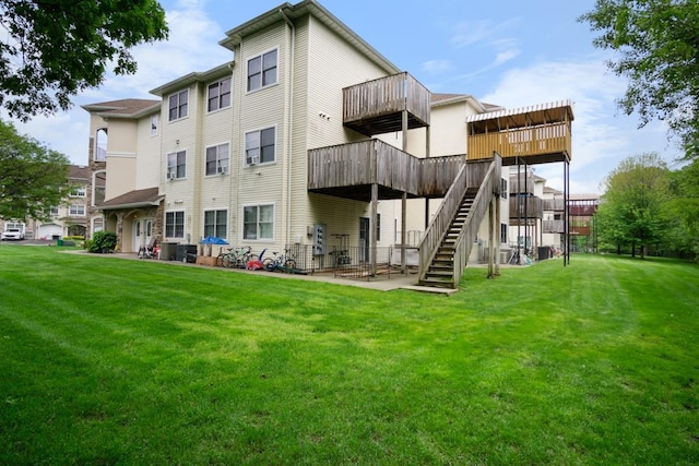 87 Horton Dr, Monsey, NY 10952 - back of property featuring stairway, a yard, a wooden deck, a patio, and central air condition unit
