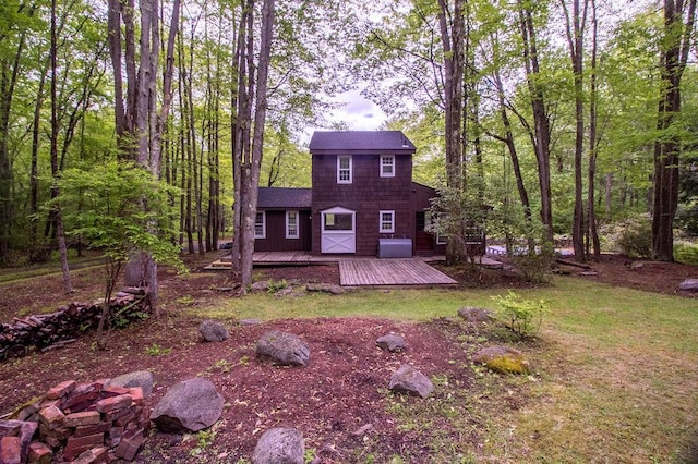 22 Mount Laurel Rd, Greenfield Park, NY 12435 - view of front facade with a wooden deck, a shingled roof, and a forest view