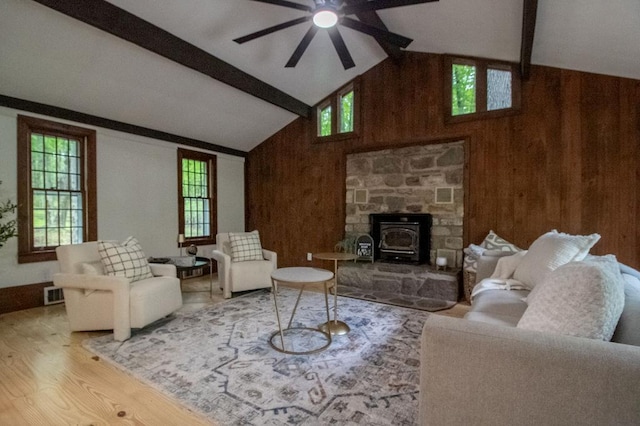 22 Mount Laurel Rd, Greenfield Park, NY 12435 - living room with wood finished floors, beamed ceiling, a wood stove, plenty of natural light, and a ceiling fan