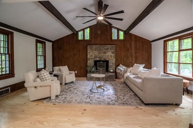 22 Mount Laurel Rd, Greenfield Park, NY 12435 - living room featuring wood finished floors, beam ceiling, wood walls, ceiling fan, and a wood stove
