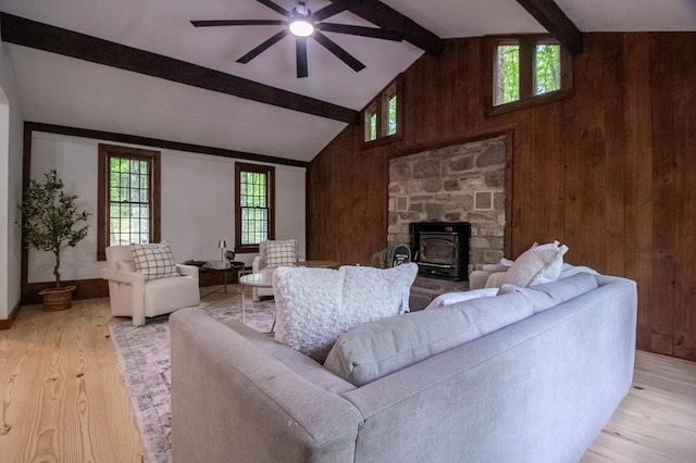 22 Mount Laurel Rd, Greenfield Park, NY 12435 - living room with wooden walls, beamed ceiling, a ceiling fan, light wood finished floors, and a wood stove