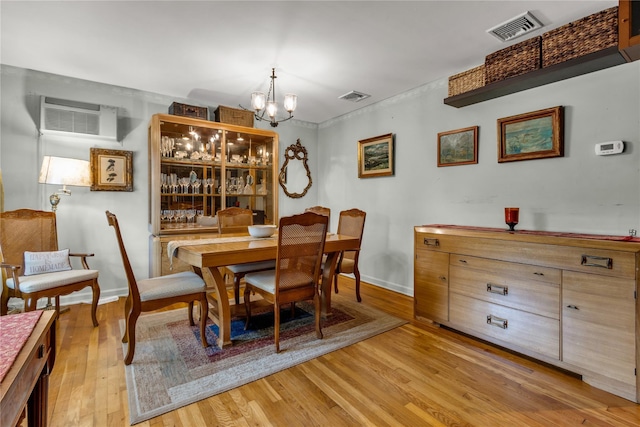 8 Cedar St, Tappan, NY 10983 - dining room featuring a chandelier, light wood-type flooring, and a wall mounted AC