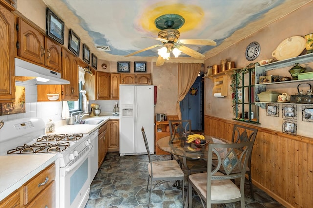 8 Cedar St, Tappan, NY 10983 - kitchen featuring white appliances, under cabinet range hood, brown cabinets, light countertops, and a wainscoted wall