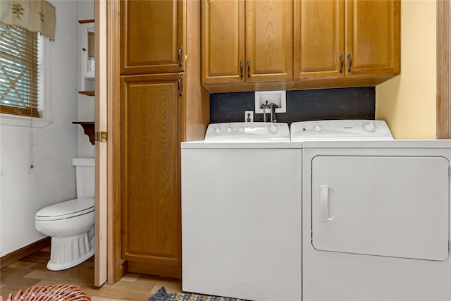 8 Cedar St, Tappan, NY 10983 - laundry area with washing machine and clothes dryer, light wood-style flooring, and cabinet space