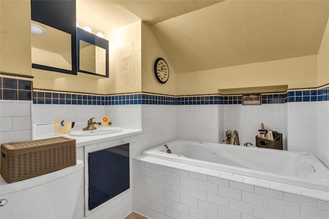 8 Cedar St, Tappan, NY 10983 - bathroom featuring tile walls, a garden tub, vaulted ceiling, and a wainscoted wall