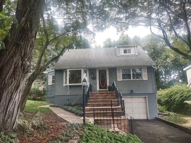 8 Cedar St, Tappan, NY 10983 - view of front facade featuring an attached garage, asphalt driveway, and roof with shingles