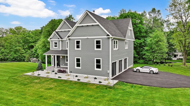 15 Somers Hills Rd, Carmel, NY 10512 - back of house featuring a porch, an attached garage, a yard, driveway, and roof with shingles
