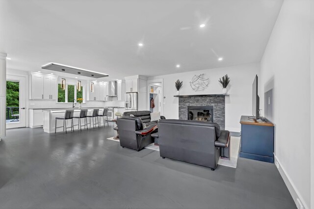 15 Somers Hills Rd, Carmel, NY 10512 - living area with a stone fireplace, recessed lighting, baseboards, and concrete flooring