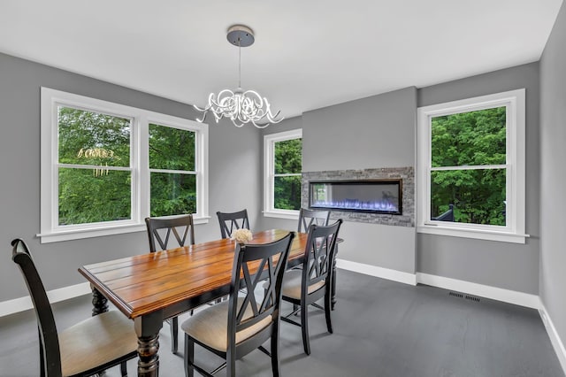 15 Somers Hills Rd, Carmel, NY 10512 - dining room featuring baseboards, a chandelier, and finished concrete floors