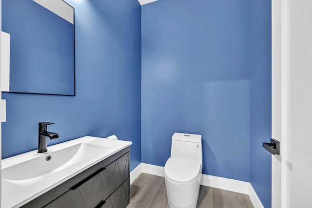 15 Somers Hills Rd, Carmel, NY 10512 - bathroom with wood finished floors, toilet, vanity, and baseboards
