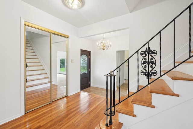 2 Sagamore Ave, Suffern, NY 10901 - entryway with stairway, wood finished floors, and a chandelier