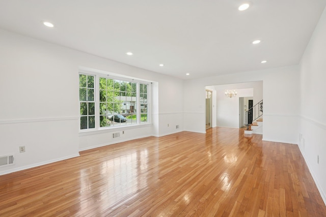 2 Sagamore Ave, Suffern, NY 10901 - empty room featuring a chandelier, stairs, light wood-type flooring, and recessed lighting