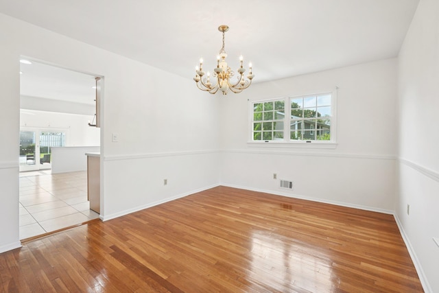 2 Sagamore Ave, Suffern, NY 10901 - spare room featuring a chandelier, healthy amount of natural light, and hardwood / wood-style flooring