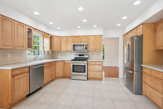 2 Sagamore Ave, Suffern, NY 10901 - kitchen with appliances with stainless steel finishes, glass insert cabinets, decorative backsplash, light countertops, and recessed lighting