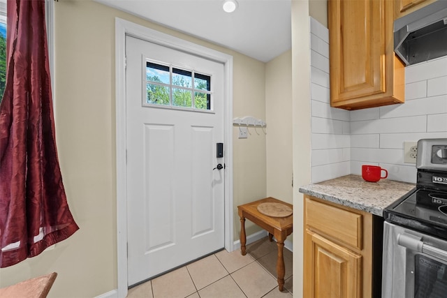 22 Claremont Trl, Monroe, NY 10950 - kitchen with stainless steel range with electric stovetop, ventilation hood, light tile patterned flooring, decorative backsplash, and baseboards