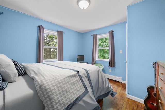 22 Claremont Trl, Monroe, NY 10950 - bedroom featuring multiple windows, a baseboard radiator, baseboards, and wood finished floors