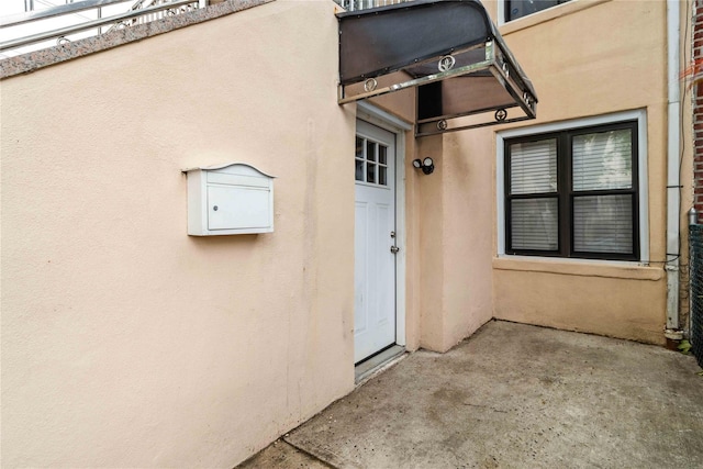 987 Pierce Ave, Bronx, NY 10462 - property entrance featuring stucco siding and a patio