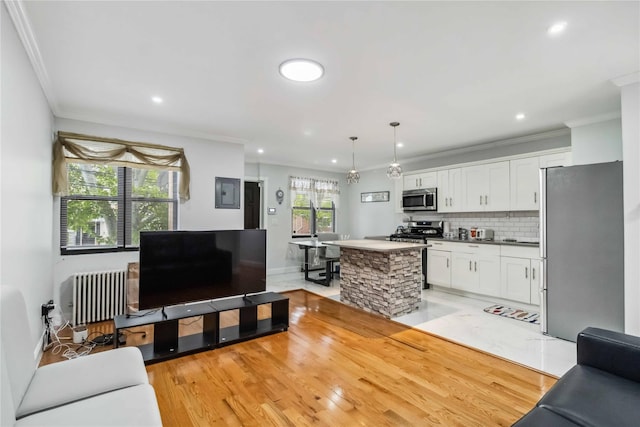 987 Pierce Ave, Bronx, NY 10462 - living room with radiator, ornamental molding, recessed lighting, and light wood finished floors