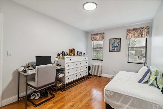 987 Pierce Ave, Bronx, NY 10462 - bedroom with radiator heating unit, multiple windows, wood finished floors, and baseboards