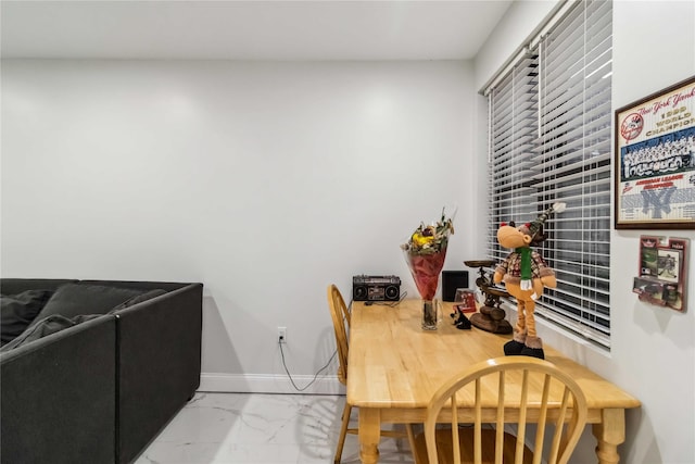 987 Pierce Ave, Bronx, NY 10462 - dining room with marble look tile flooring and baseboards