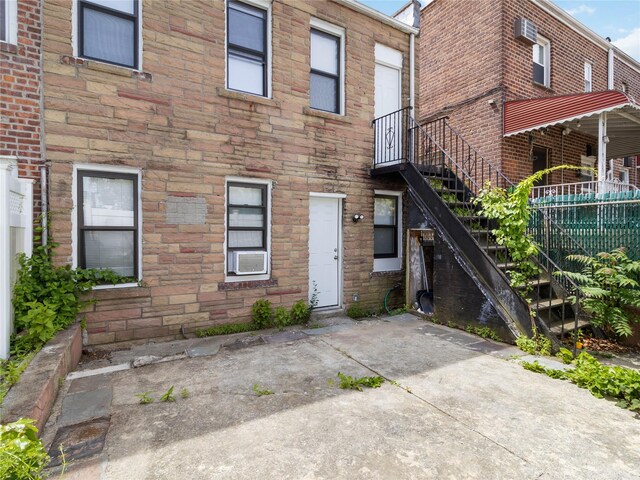 987 Pierce Ave, Bronx, NY 10462 - back of house with stone siding, stairs, and cooling unit