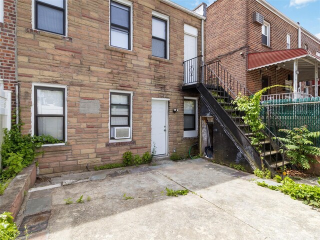 987 Pierce Ave, Bronx, NY 10462 - view of front of property featuring stairs, stone siding, and cooling unit