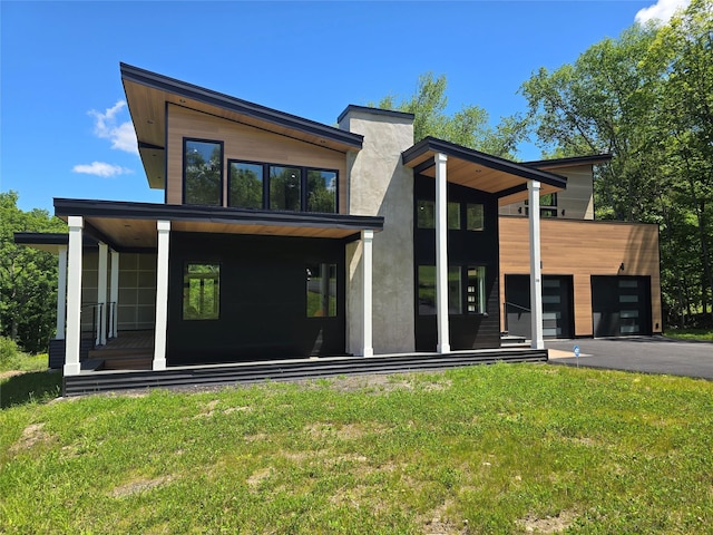 30 Coleman Dr, Campbell Hall, NY 10916 - view of front of home with asphalt driveway, a front lawn, covered porch, and an attached garage