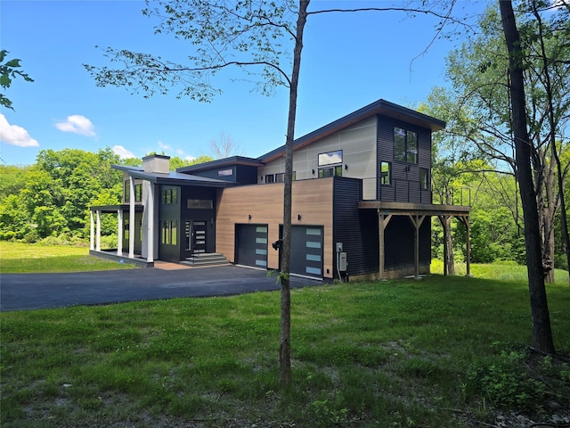 30 Coleman Dr, Campbell Hall, NY 10916 - contemporary home featuring a front yard, asphalt driveway, a chimney, and a garage