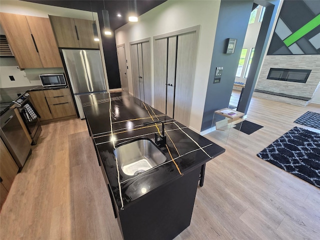 30 Coleman Dr, Campbell Hall, NY 10916 - kitchen with appliances with stainless steel finishes, light wood-style flooring, brown cabinetry, and dark countertops