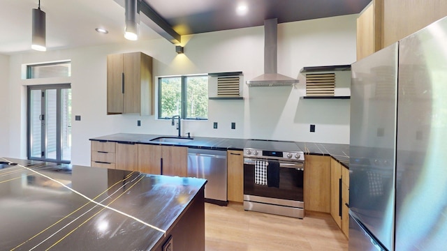 30 Coleman Dr, Campbell Hall, NY 10916 - kitchen featuring stainless steel appliances, a sink, wall chimney range hood, modern cabinets, and light wood-type flooring