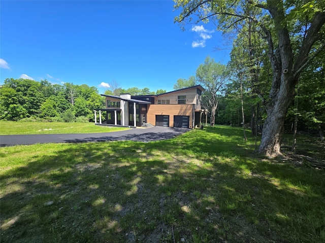 30 Coleman Dr, Campbell Hall, NY 10916 - view of front of property featuring an attached garage, asphalt driveway, and a front yard