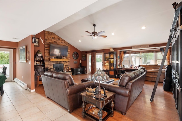 1 Angelica Ct, West Babylon, NY 11704 - living room featuring baseboard heating, a fireplace, lofted ceiling, ceiling fan, and healthy amount of natural light