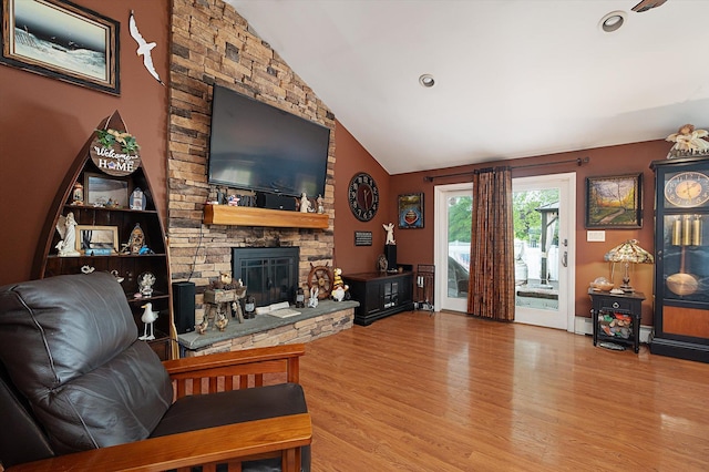 1 Angelica Ct, West Babylon, NY 11704 - living room featuring wood finished floors, lofted ceiling, and a stone fireplace