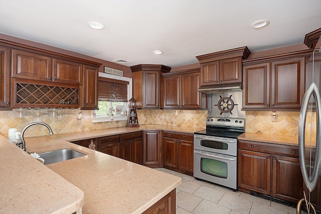 1 Angelica Ct, West Babylon, NY 11704 - kitchen with stainless steel appliances, a sink, light tile patterned floors, decorative backsplash, and recessed lighting