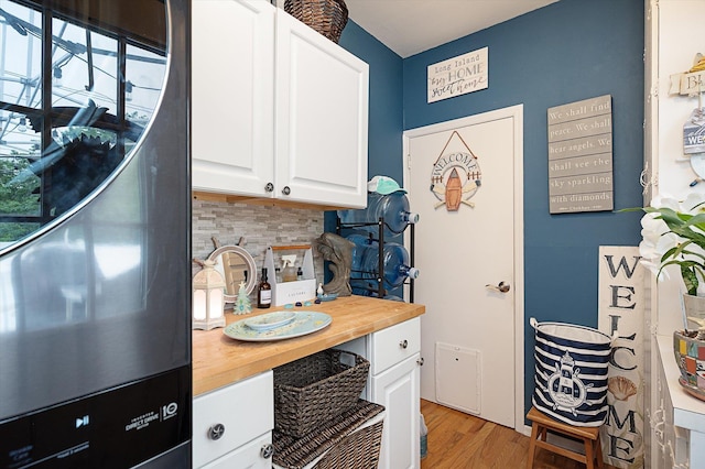 1 Angelica Ct, West Babylon, NY 11704 - kitchen with butcher block countertops, white cabinets, backsplash, and light wood-style floors
