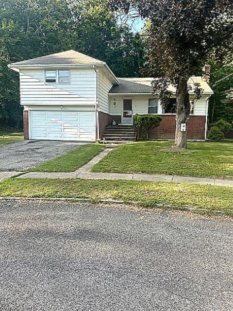5 Estelle Rd, Poughkeepsie, NY 12601 - split level home with driveway, brick siding, an attached garage, and a front yard